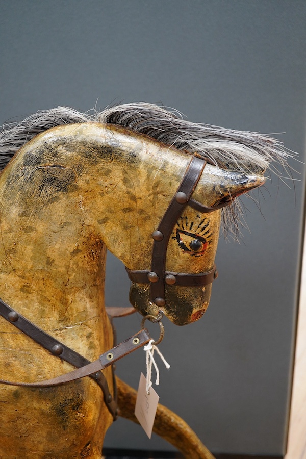 An early 20th century small dapple grey rocking horse, 92cm high, 112cm long. Condition - fair